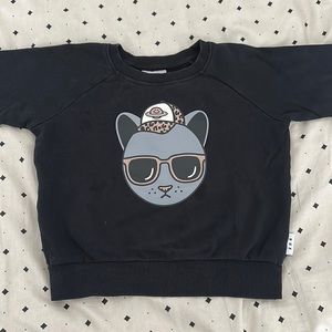 Hux baby sweatshirt. Black background, grey and beige face. Size 5T